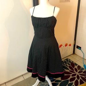 Black and white polka-dot spaghetti strap a-line dress with pink ribbon accent